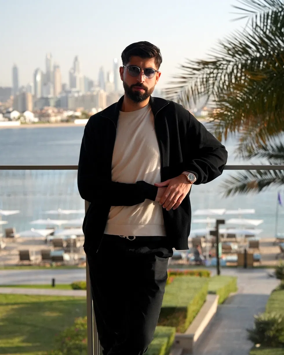 Faruk Ilkhan, who teaches the AI Dropshipping Masterclass, photographed on a balcony overlooking the Dubai skyline